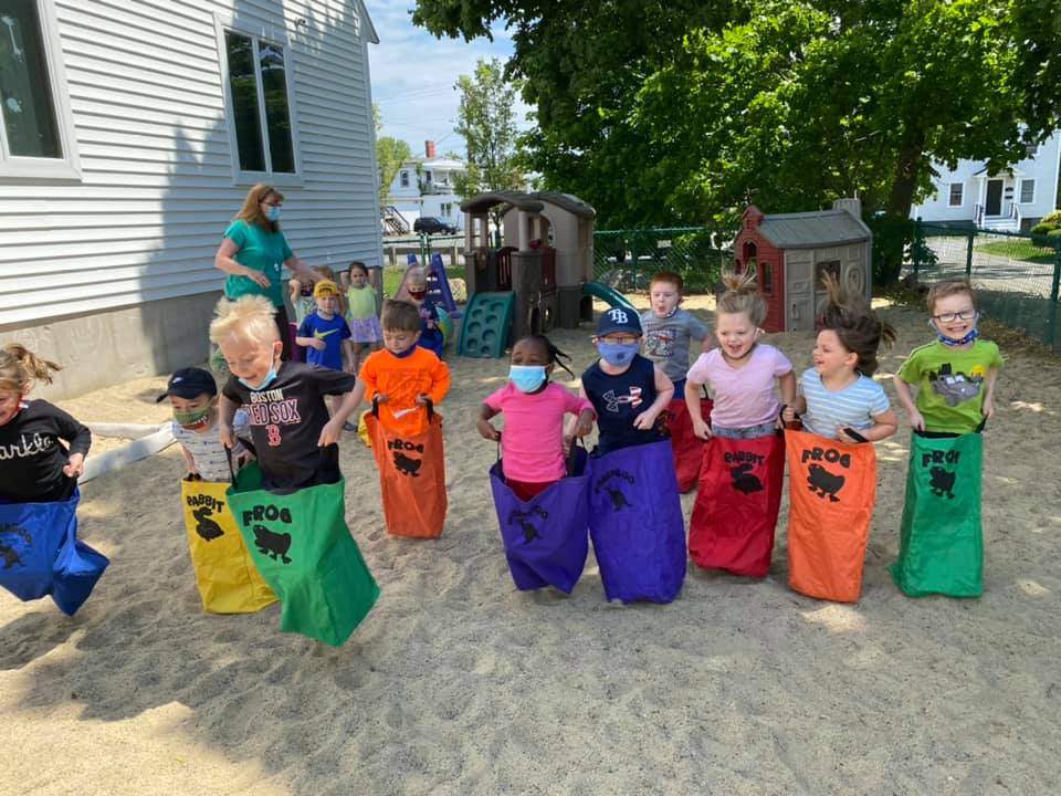 Children in play area in their jumping bags.